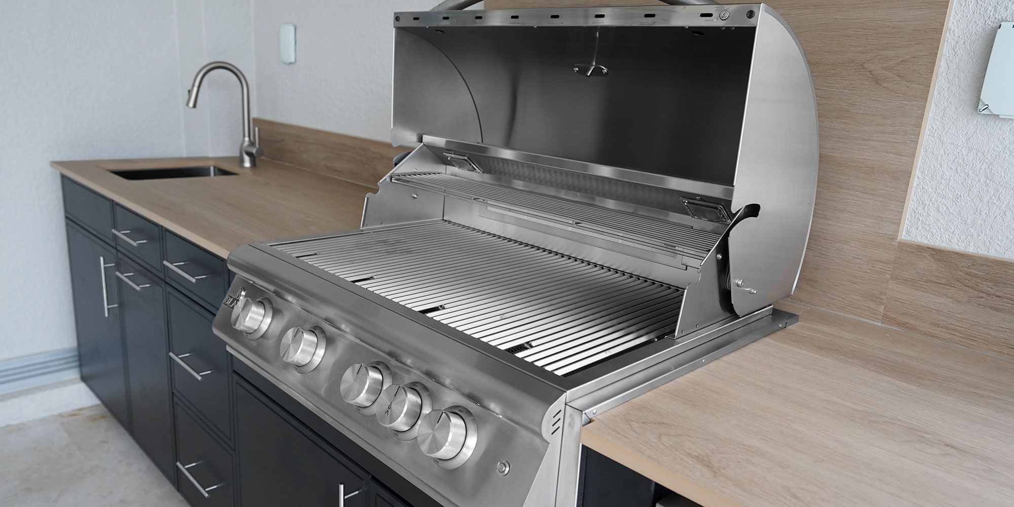 Project #97 - Black Outdoor Kitchen 4 Enclosed grill with opened hood soeing four burners