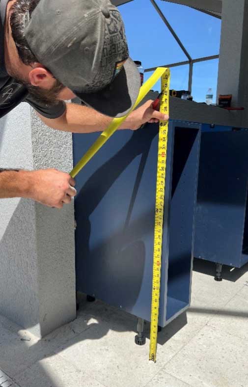 Project #95: Premium Outdoor Kitchen Showcase 9 Premier outdoor kithcen installation - leveling cabinets